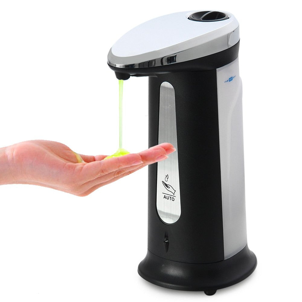 Black and silver automatic soap dispenser dispensing soap into a hand on a white background