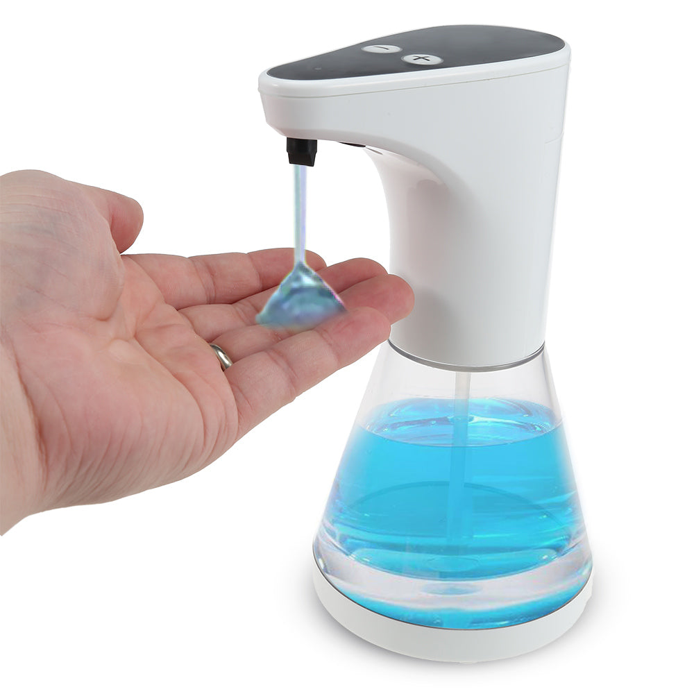 Hand pressing an automatic soap dispenser with blue liquid on a white background